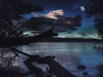 Scenic view of lake against sky at dusk