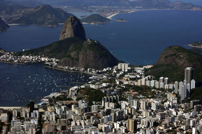 High angle view of buildings by sea against sky