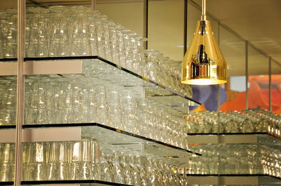 Empty sundae glasses arranged on shelves at ice cream parlor