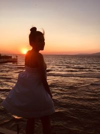 A wonderful sunset at the sea with a young lady 