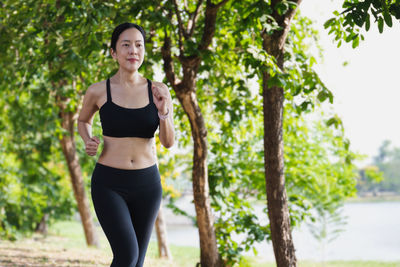 Woman running outside in park in beautiful summer.