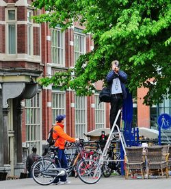 Man riding bicycle in front of building