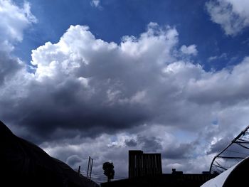 Low angle view of silhouette buildings against sky