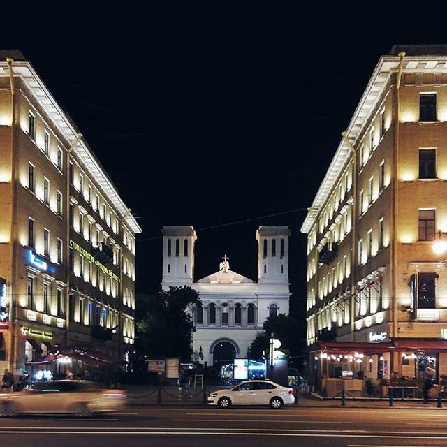 building exterior, architecture, built structure, city, car, street, transportation, land vehicle, road, city street, mode of transport, building, city life, illuminated, night, residential building, residential structure, street light, incidental people, outdoors