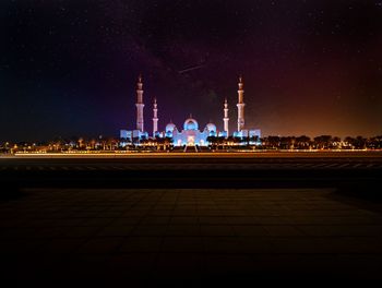 Illuminated building against sky at night