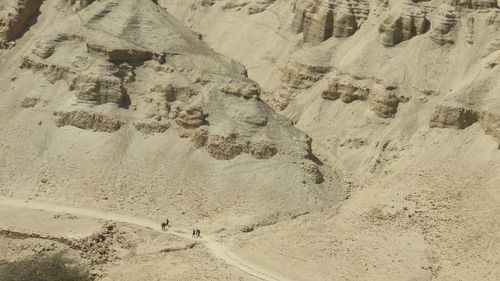 Distant view of people hiking at negev desert