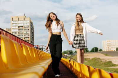 Teenage girls relax together in the school stands. the concept of friendship and relationships