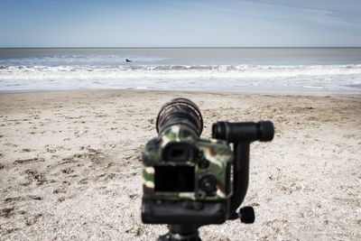 View of camera on beach against sea