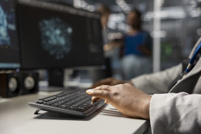 Midsection of businessman using laptop