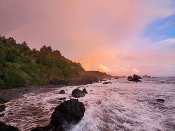 Sunset rainbow over pacific ocean