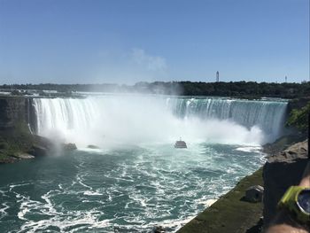 Scenic view of waterfall against sky