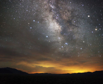 Scenic view of silhouette mountain against sky at night