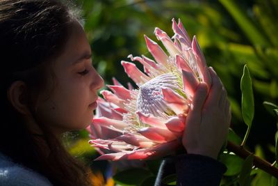 Close-up of girl with pink flowers