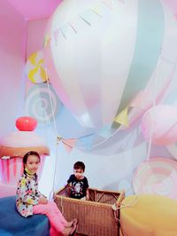 Rear view of couple with multi colored balloons