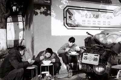 Group of people sitting on table