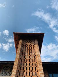 Low angle view of building against cloudy sky
