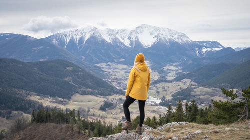 Rear view of man standing against mountain