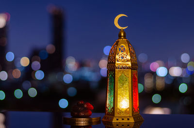 Lantern with moon symbol on top and dates fruit for ramadan kareem and islamic new year concept.