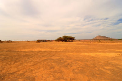Scenic view of desert against sky during sunset