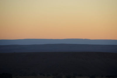 Scenic view of silhouette landscape against sky during sunset