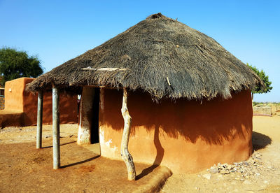 Mud huts in village at rajasthan against clear sky
