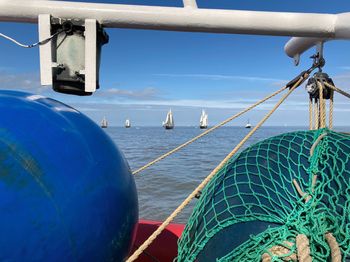 Close-up of sailboat in sea against sky