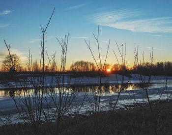 Scenic view of lake against sky during sunset