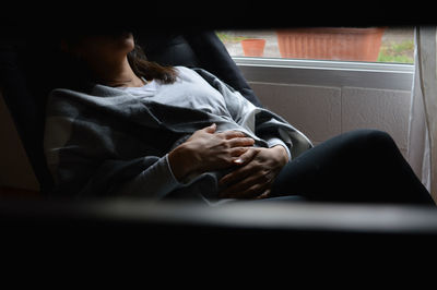 Midsection of woman sitting in bus