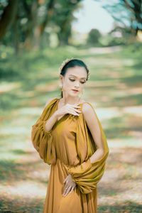 Portrait of young woman standing outdoors