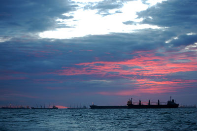 Silhouette sailboats on sea against sky during sunset