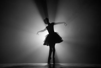 Silhouette ballet dancer dancing on stage
