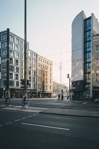 View of city street and buildings against sky