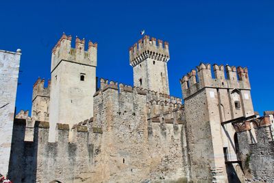 Low angle view of historic building against blue sky