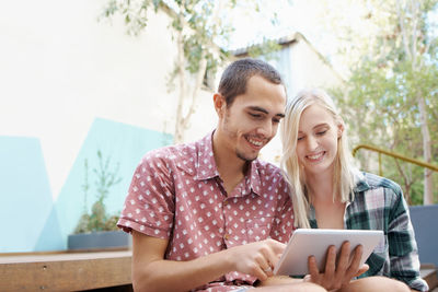 Smiling couple looking at digital tablet