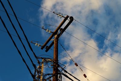 Low angle view of electricity pylon against sky