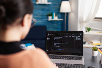 Woman using laptop at home