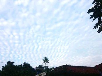 Low angle view of building against cloudy sky