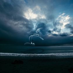 Scenic view of sea against cloudy sky