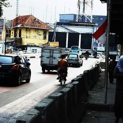 Rear view of people on street in city