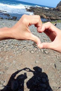 Close-up of hands on sand