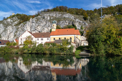 Houses in a lake with buildings in background