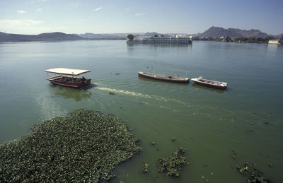 Boats in sea against sky