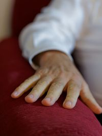 Close-up of human hand on sofa