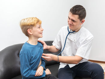 Boy sitting in a room