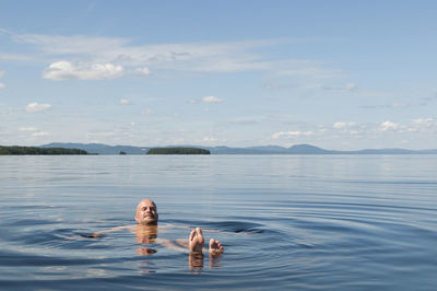 Mature man swimming in sea