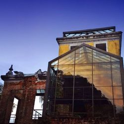 Low angle view of building against clear blue sky