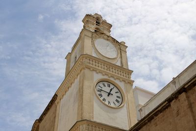 Low angle view of clock tower against sky