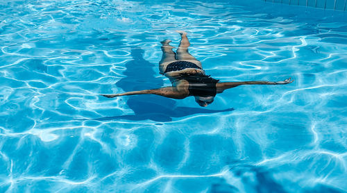 Young woman in bikini in swimming pool. summer, lifestyle.