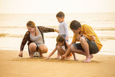 Rear view of people on beach