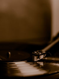 Record deck and vinyl record close up with copy space sepia tone